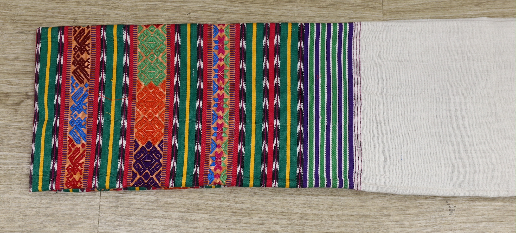 A Guatemalan shawl, the lower part polychrome woven with chevrons, stylised flowers and geometric devices, 170 x 87cm